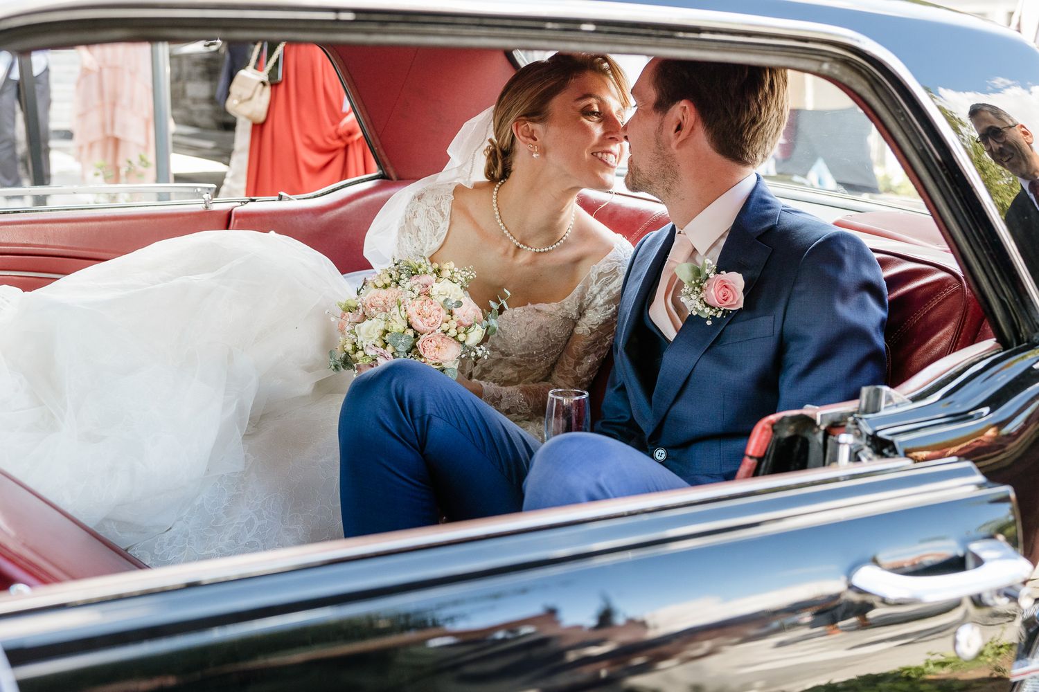 Baiser des maries dans la voiture en quittant la ceremonie avant d'aller au chateau du biez pour la reception de leur mariage