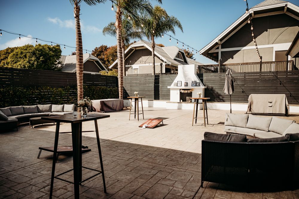 Outdoor wedding venue space with palm trees and modern seating area.