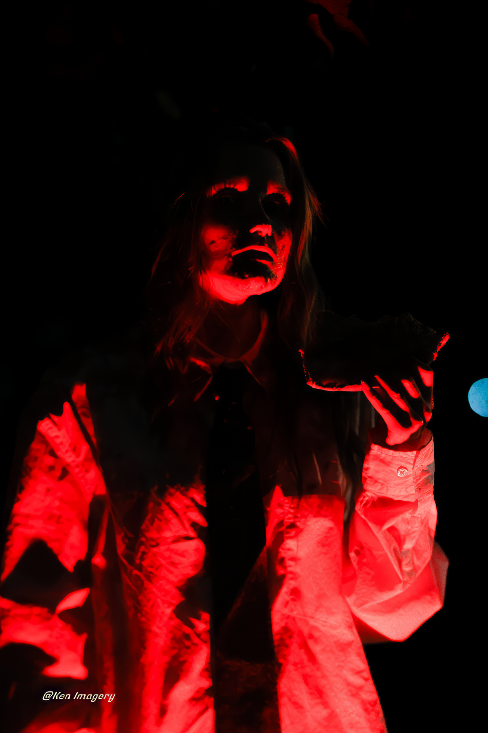 A series of dark red-lit silhouettes show someone performing dramatic poses in a shadowy artistic photoshoot.