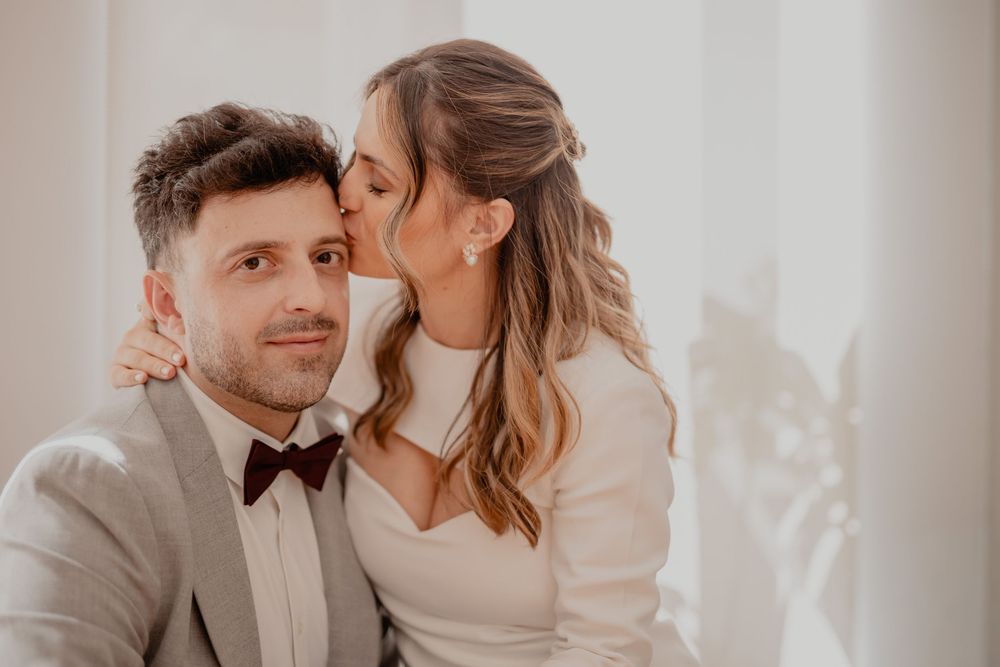 Romantic couple in wedding attire share intimate moments in a series of warm-toned photos.