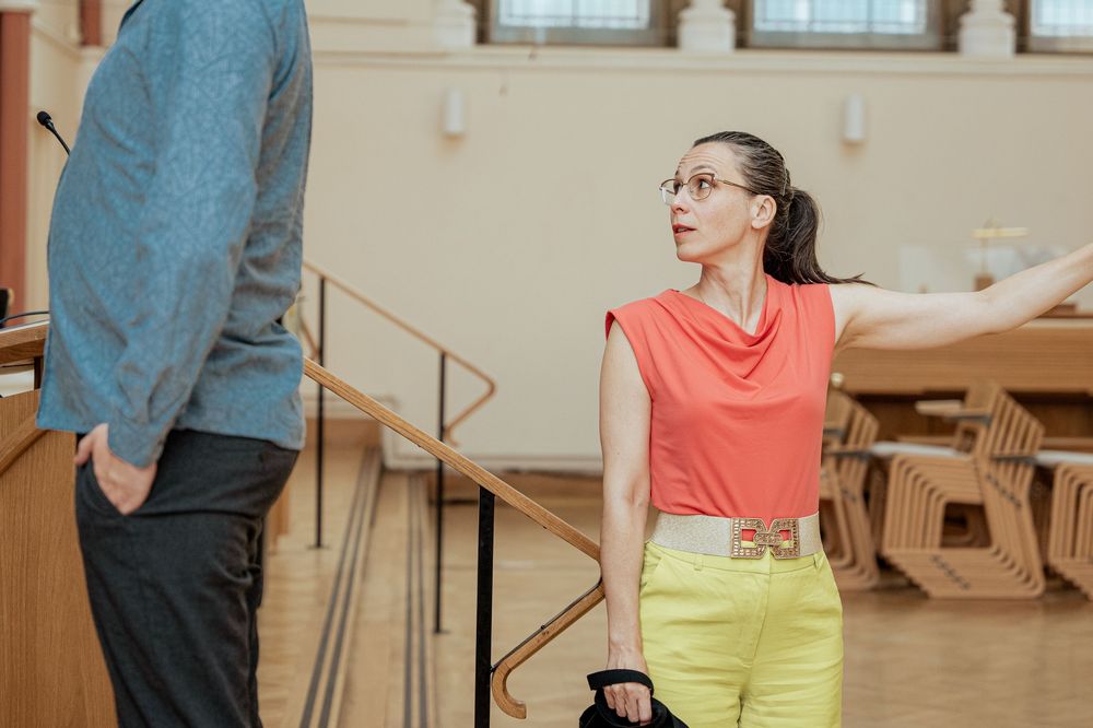 Dance students learning new steps in a spacious practice room.
