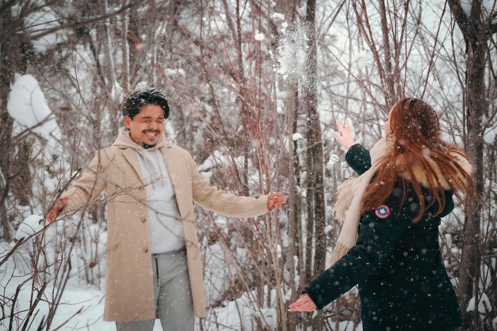Winter photoshoot sequence showing couple playing in snowy forest setting.