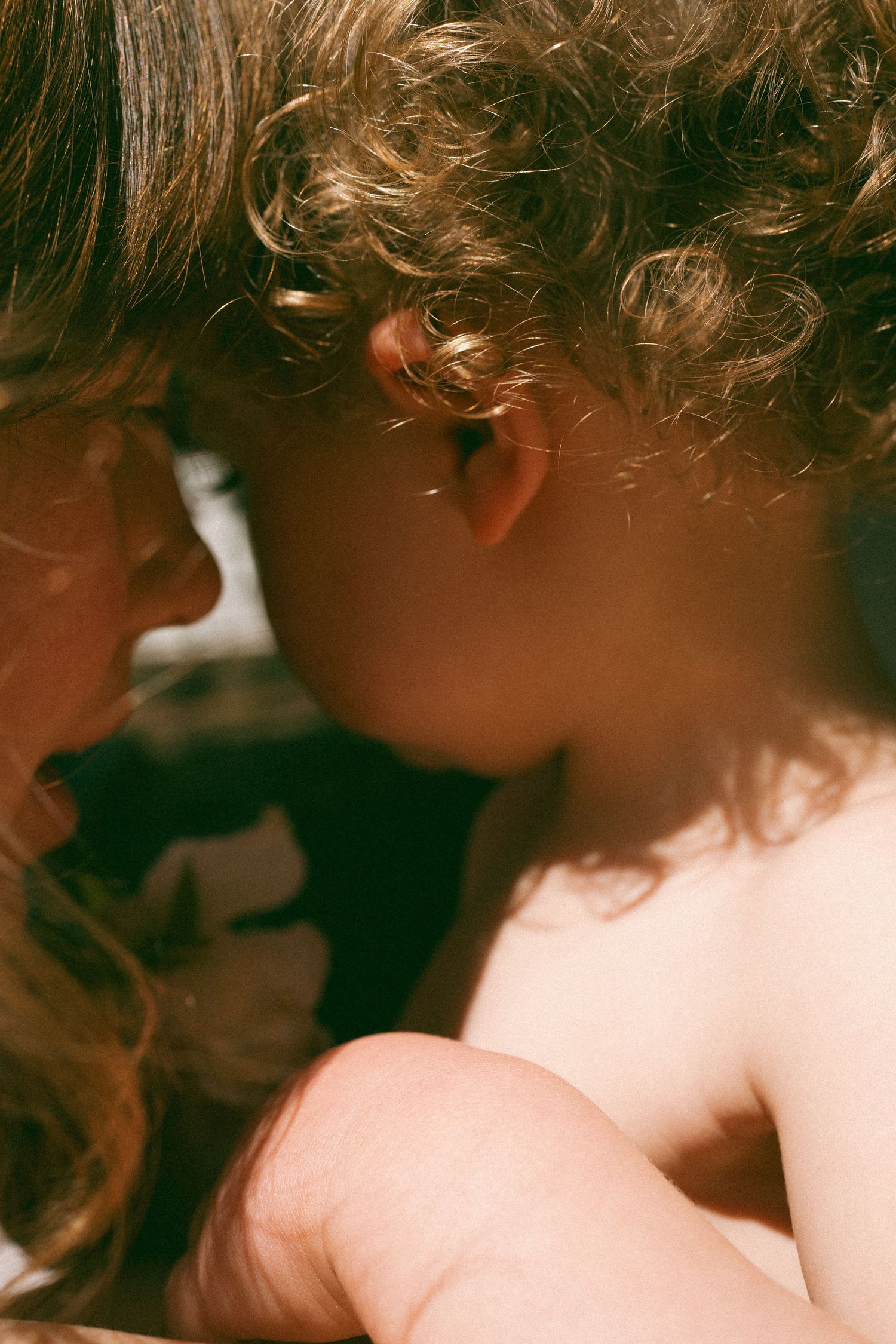 Soft focus close-up portrait in warm sepia tones.
