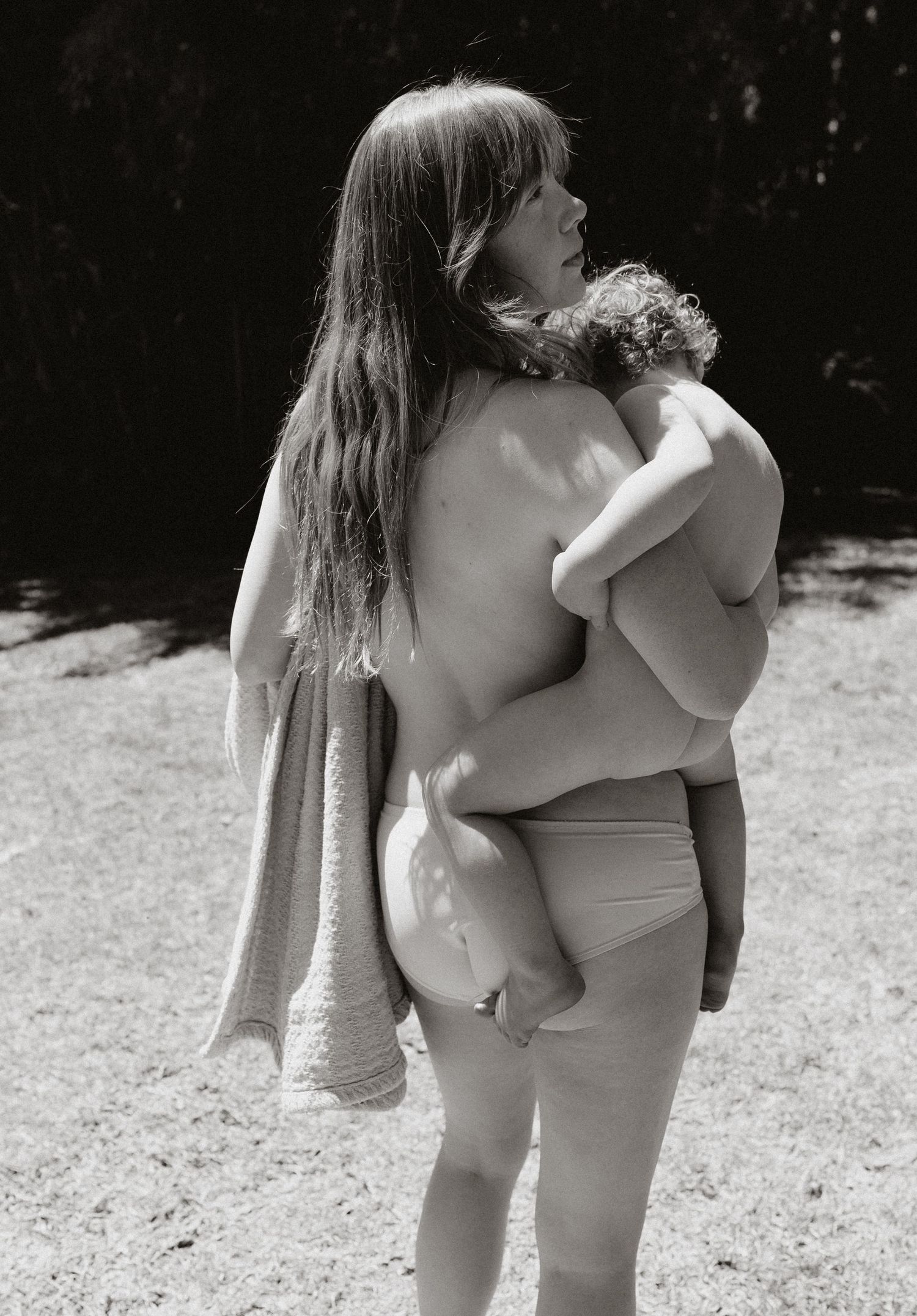 Black and white artistic photograph showing intimate connection in natural light.
