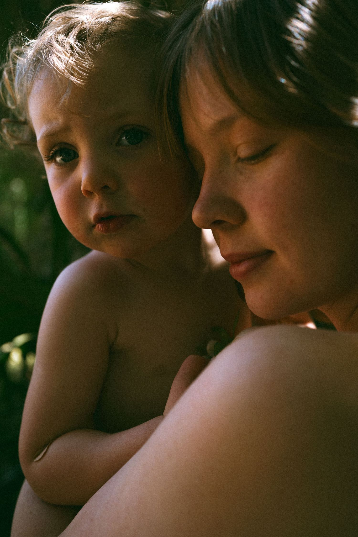 Close-up portrait capturing tender moment between parent and child.