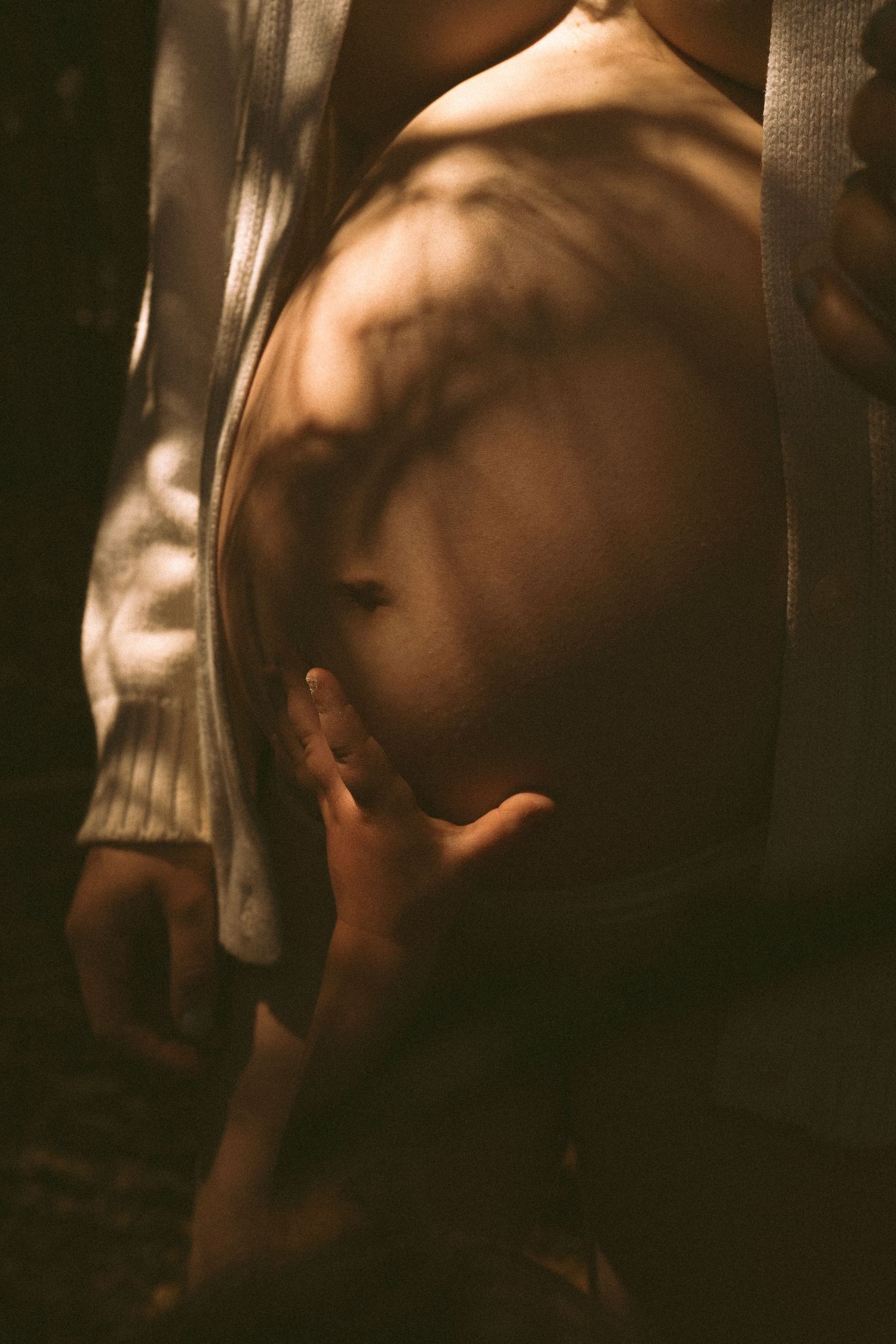 Artistic portrait series in sepia tones showing ethereal movement and flowing fabric in dim lighting.