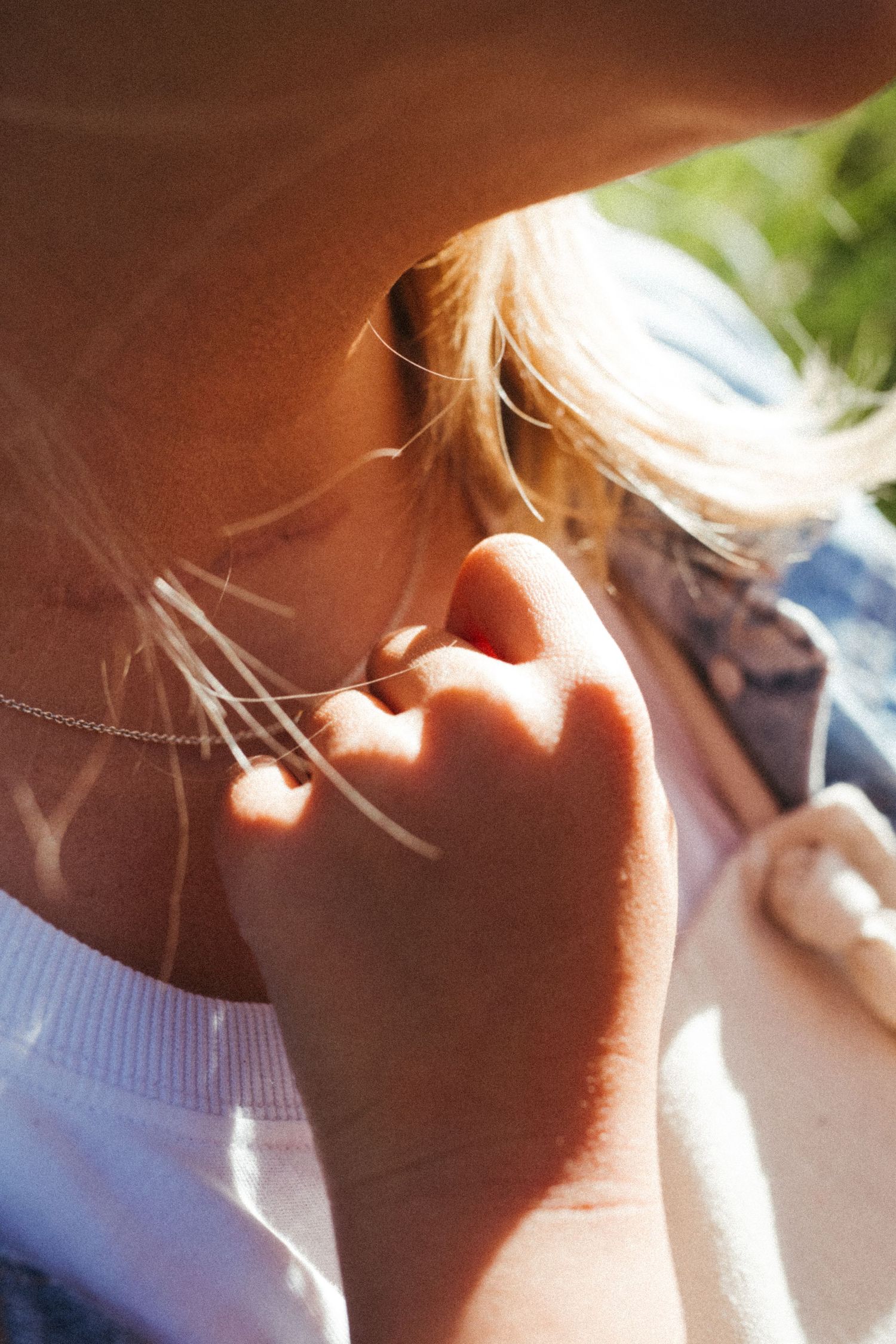 A close-up artistic shot shows sunlit profiles in warm tones.