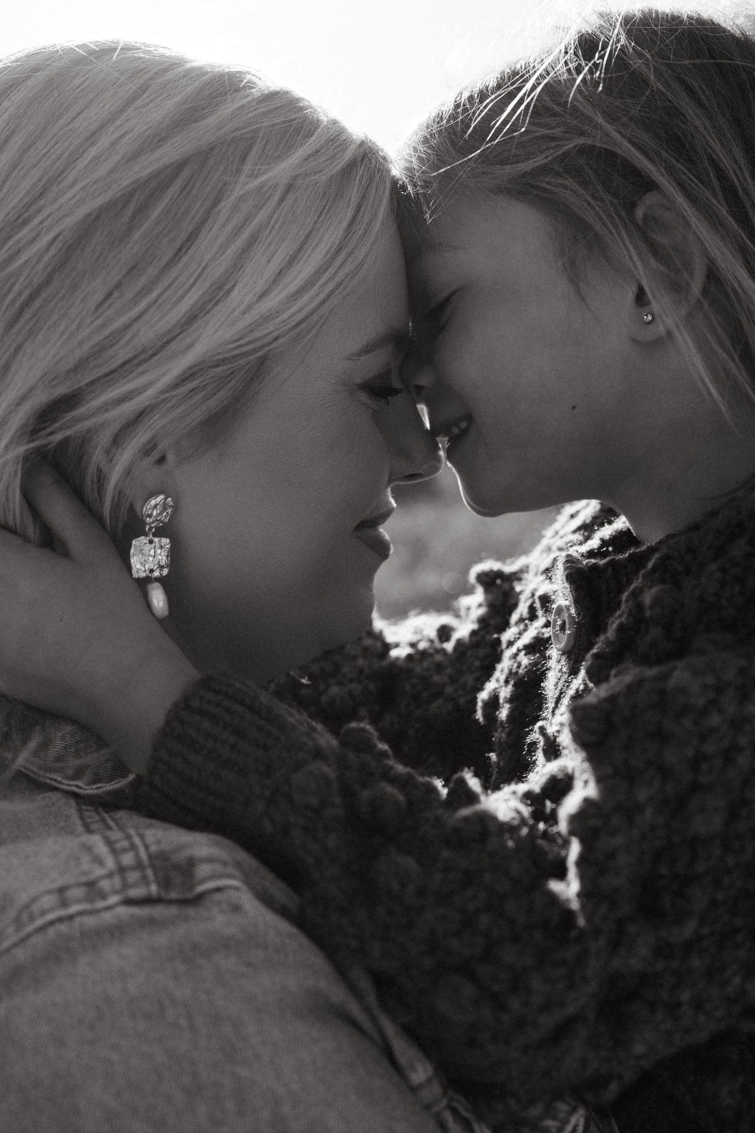 An intimate black and white portrait sequence showing a gentle moment between two people.