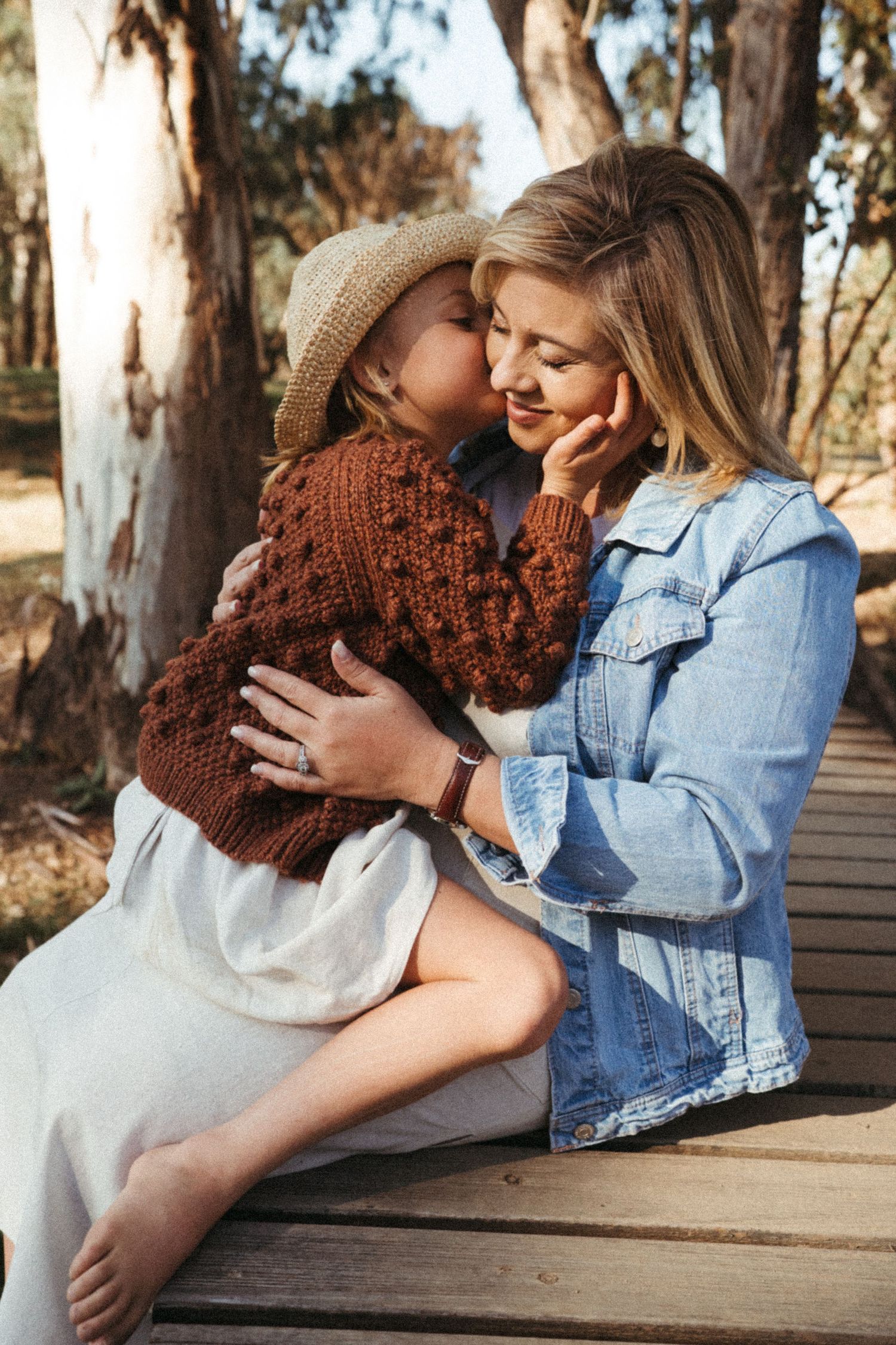 Candid outdoor photography sequence capturing warm embraces between two people in natural lighting.