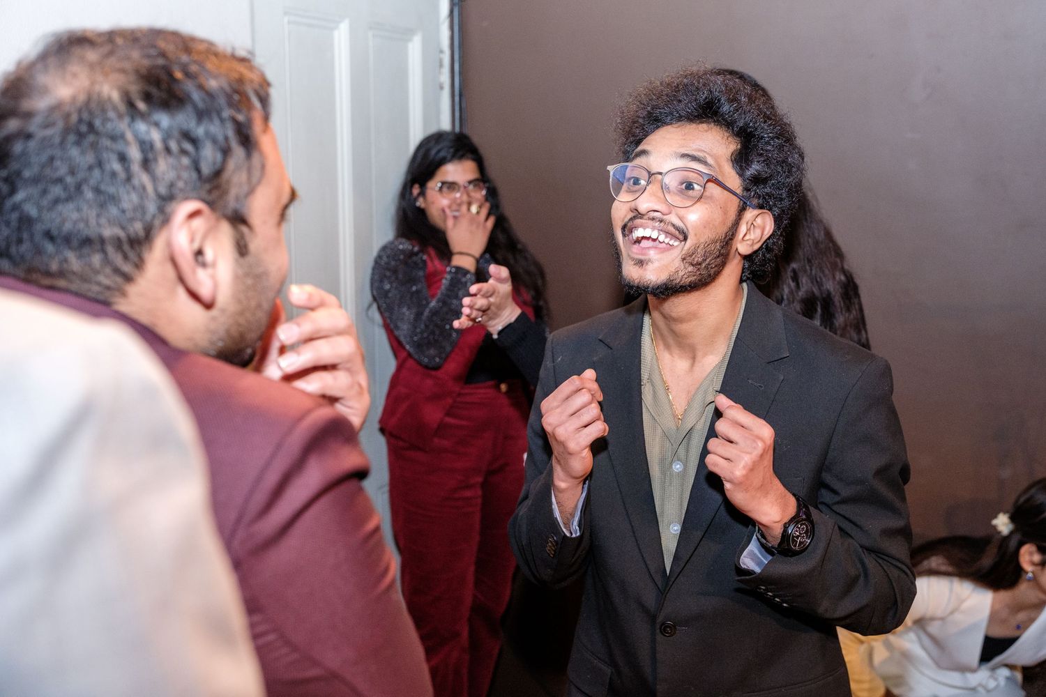 A sequence of candid photos showing two people engaged in animated conversation and laughter.