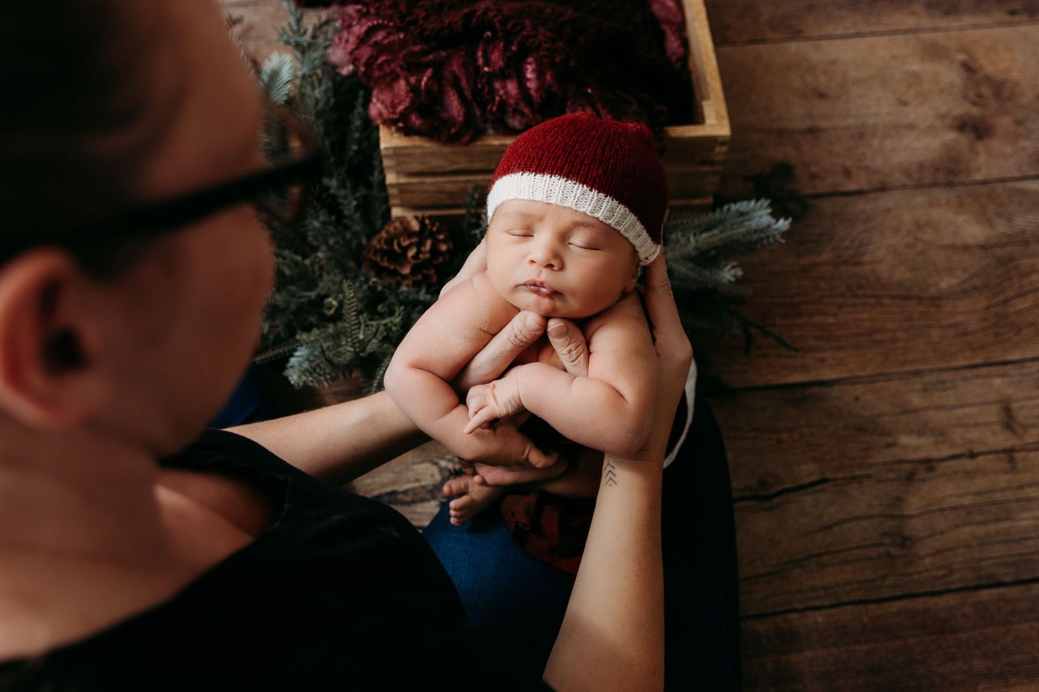 Artistic newborn photography series featuring sleeping baby on rustic wooden backdrop.