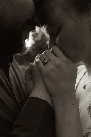 Artistic black and white close-up of romantic moment between couple.