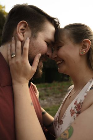 Candid close-up of couple laughing together during outdoor photoshoot.