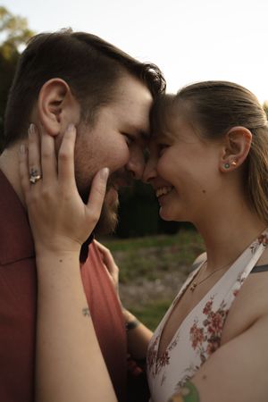Intimate close-up portrait of couple sharing tender moment in natural lighting.