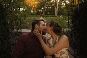 An intimate autumn photoshoot with warm lighting filtering through trees in the background.
