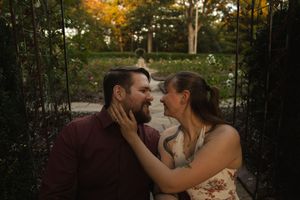 A romantic outdoor portrait session with autumn foliage creating a natural backdrop.
