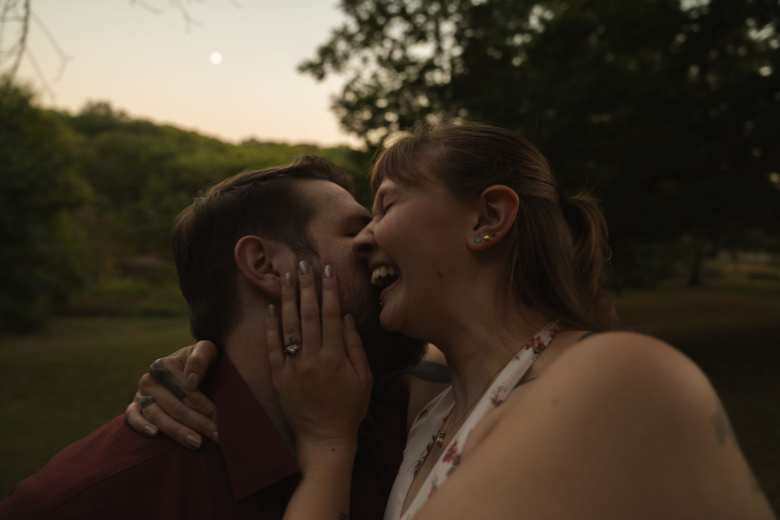Intimate moment captured between couple during golden hour in nature.