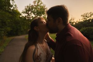Close-up of couple sharing romantic moment during outdoor sunset photo session.