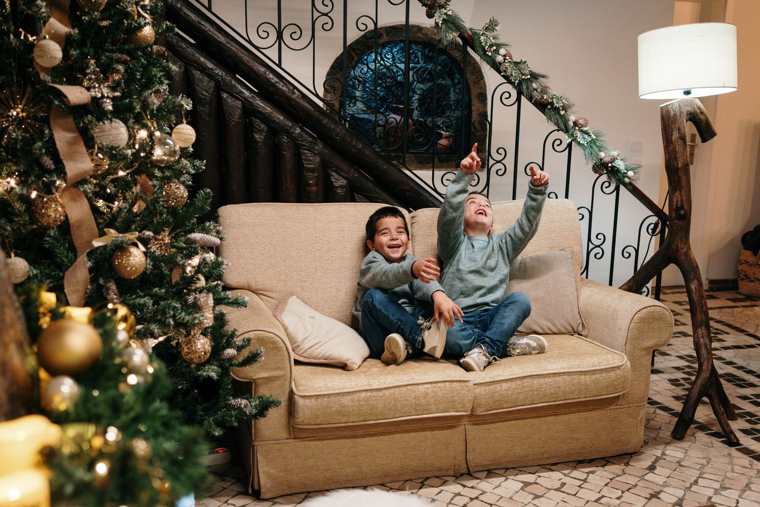 Cozy family Christmas scene with decorated tree and soft lighting in living room.
