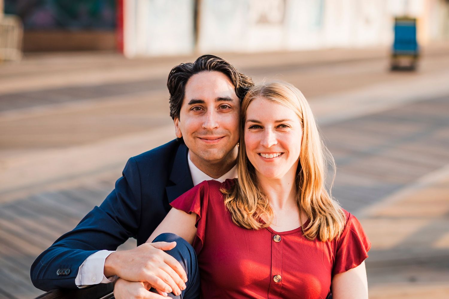 A couple in formal attire shares tender moments in a series of photos on a boardwalk.