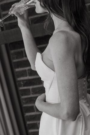 Black and white images of bridesmaids in white dresses preparing for a wedding.