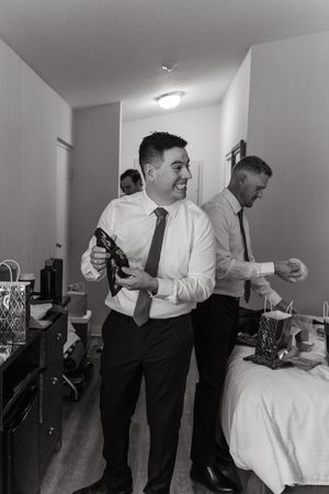 A sequence of black and white photos showing two people in formal attire interacting in what appears to be a hotel room.