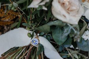 A "I voted" sticker attached to a bouquet of flowers with green foliage and white roses.