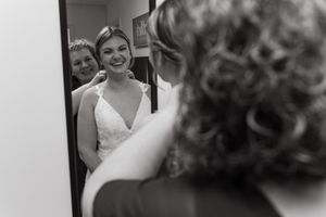 A series of black and white wedding photos showing candid moments of a bride in a white dress.