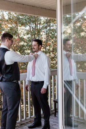 A sequence of photos showing two men in suits demonstrating self-defense moves on a white porch.