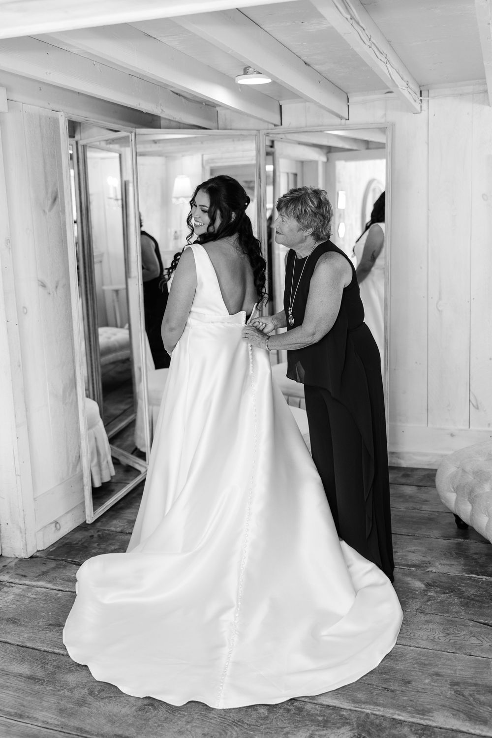 A series of black and white photos showing the flowing train of a wedding dress on a wooden floor.