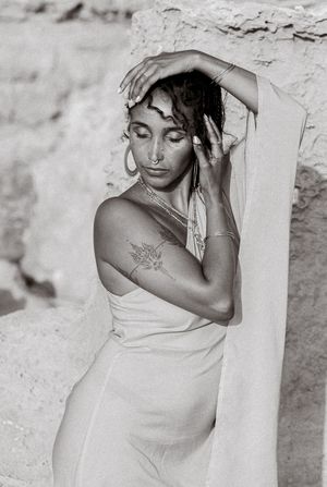 Black and white portrait series showing artistic poses against a textured wall.