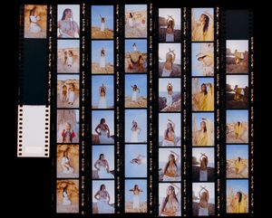 Film contact sheet showing artistic photoshoot poses against rocky coastal backdrop.