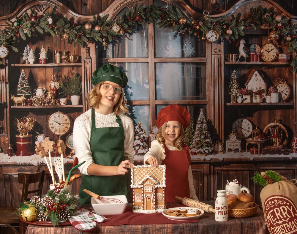 Cozy Christmas kitchen scene with gingerbread house decorating, baking supplies, and festive holiday decor.