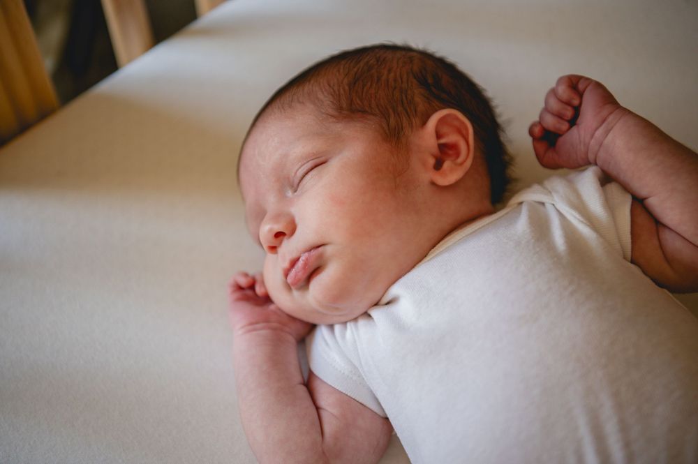 A series of peaceful sleeping newborn baby photos showing tiny fingers and peaceful expressions.