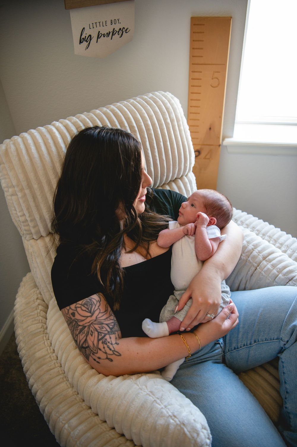 Four sequential photos show tender moments of bonding with a newborn baby while resting on a striped cushioned chair.