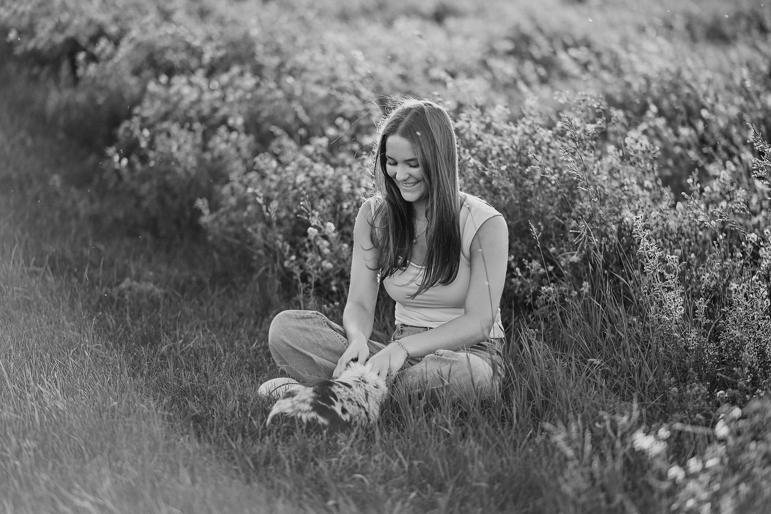 A series of romantic outdoor photos showing a couple embracing in a wildflower meadow during golden hour.