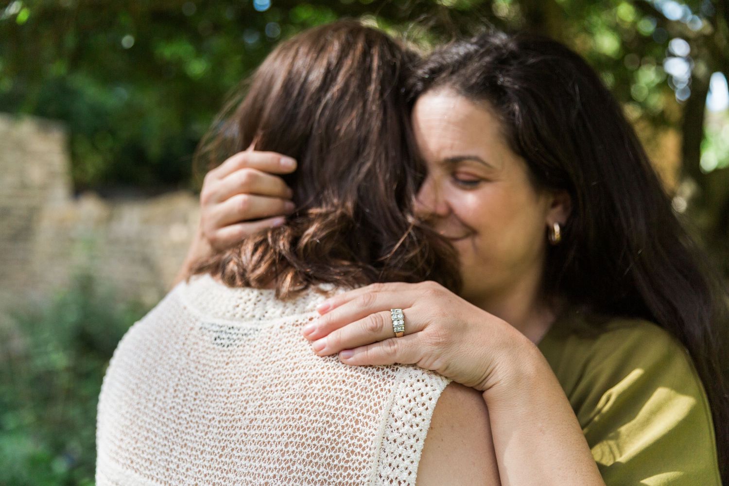 Close up of a female couple embracing closely enjoying a romantic moment of connection. Hayley Elizabeth engagement Photography Cotswolds