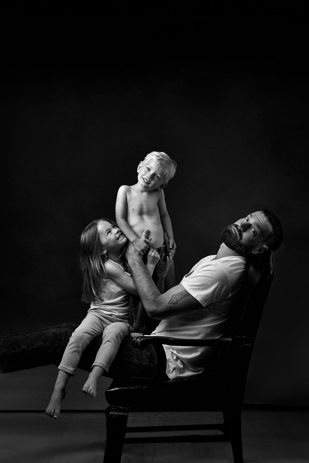 Dramatic black and white portraits showing intimate poses on a bench.