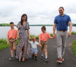 Family walking together along a waterfront path on a sunny day, captured in a series of candid moments.