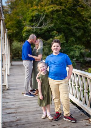 A candid series of interactions captured on a rustic wooden bridge with green foliage in the background.