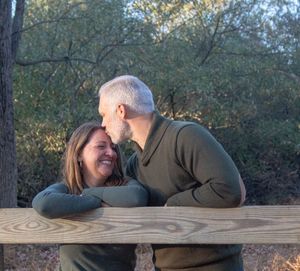 A romantic sequence of photos shows a couple sharing tender moments on a wooden deck railing at sunset.