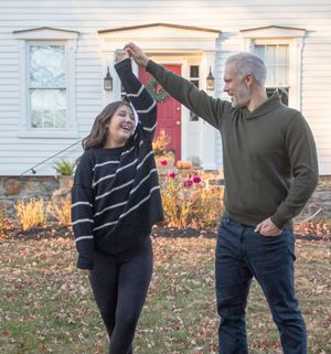 A sequence of photos shows two people dancing together in a yard with fallen autumn leaves.