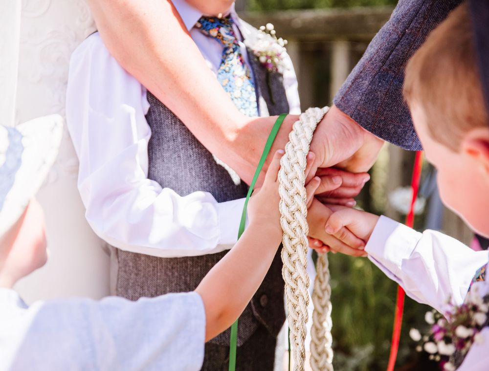 Hand fasting wedding ceremony in North Dorset from a candid wedding photographer. Relaxed Dorset Wedding photographer