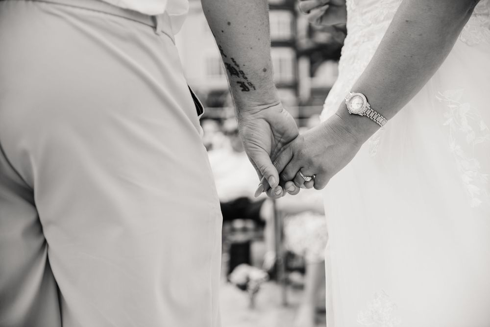 Weymouth beach wedding. Couple hold hands during wedding on the beach.  Relaxed Dorset Wedding photographer