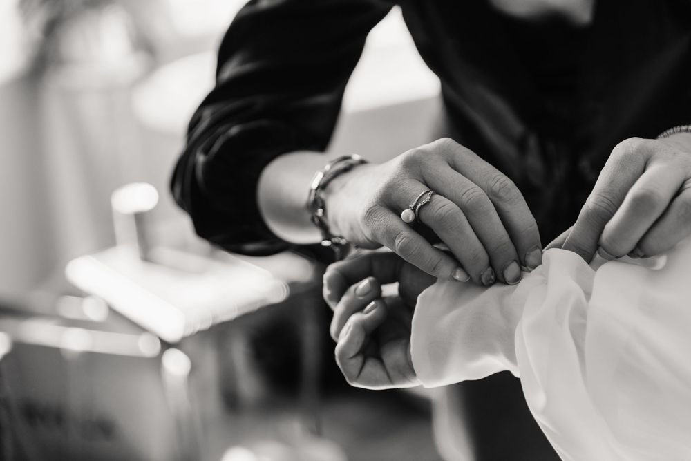 Candid photo of bride putting bracelet on at the Alverbank Hotel Gosport. From a candid Hampshire Wedding Photographer