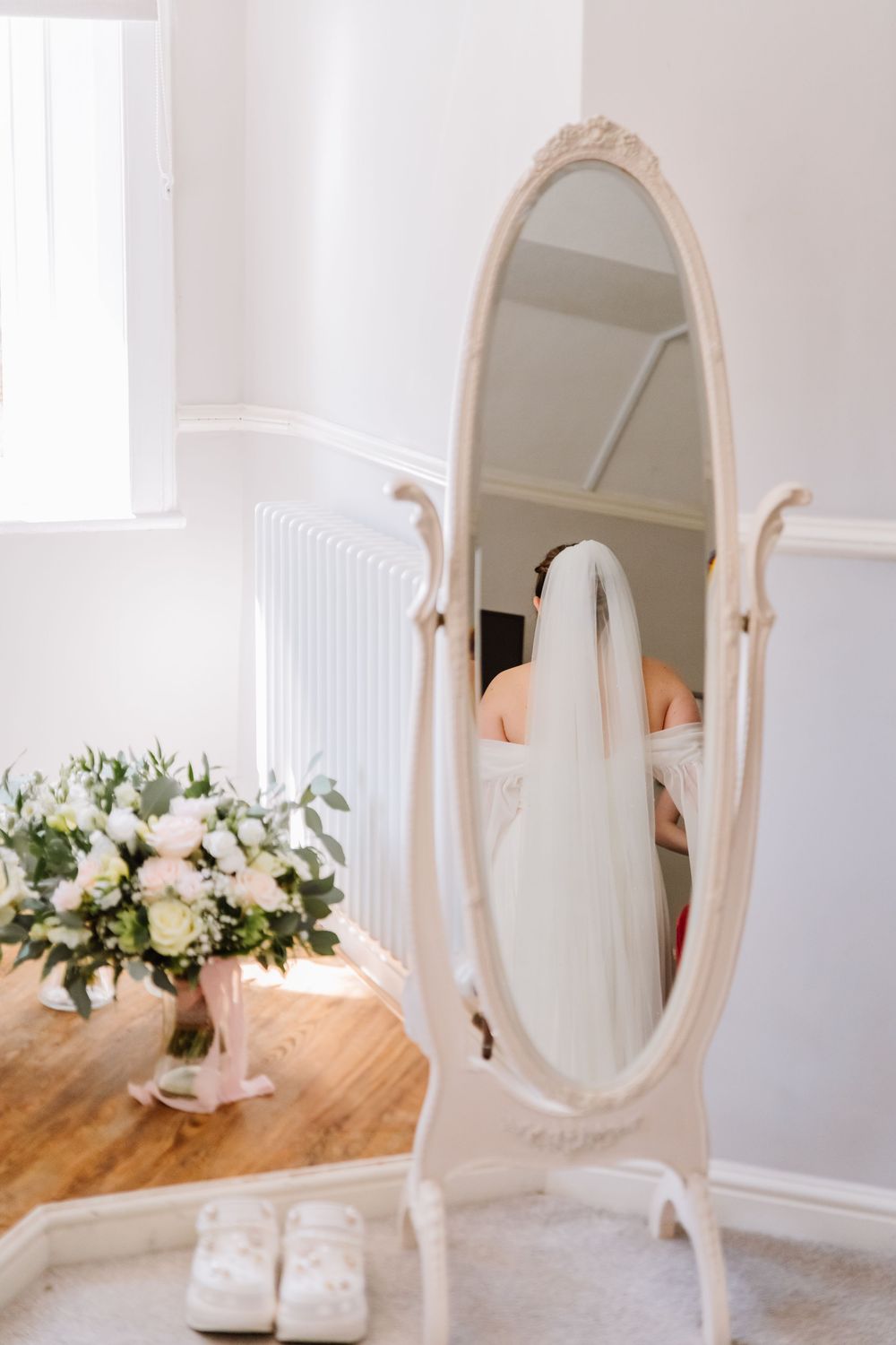 Bride in the mirror at the Alverbank Hotel Gosport. From a candid Hampshire Wedding Photographer