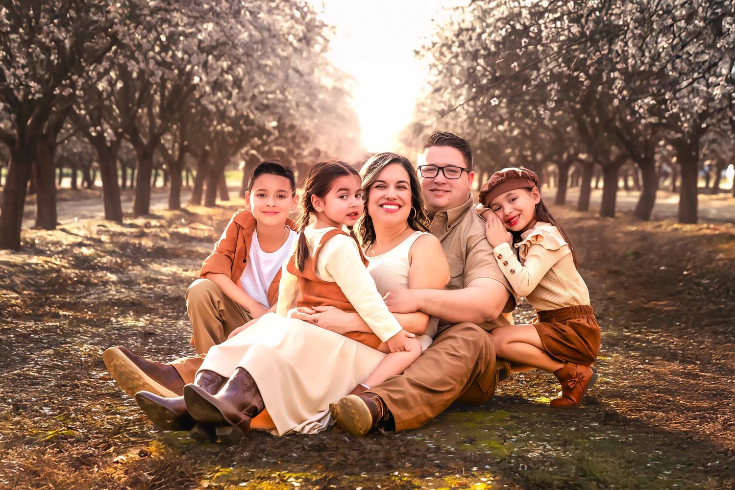 Fresno family photographer Colibri Captures outdoor family session in the local almond blossoms.