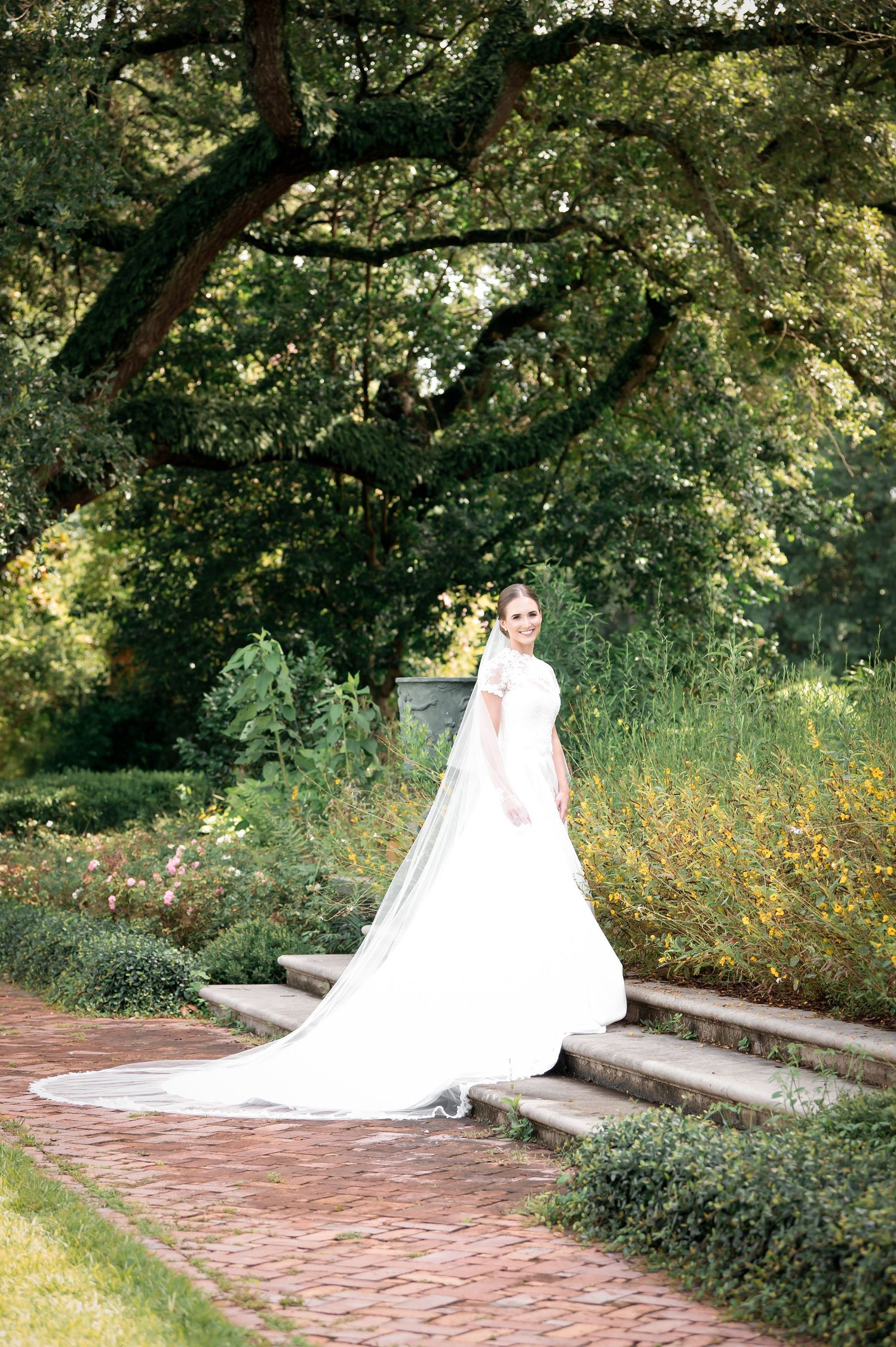 Bridal portraits captured in a serene garden setting with brick pathways and natural greenery.