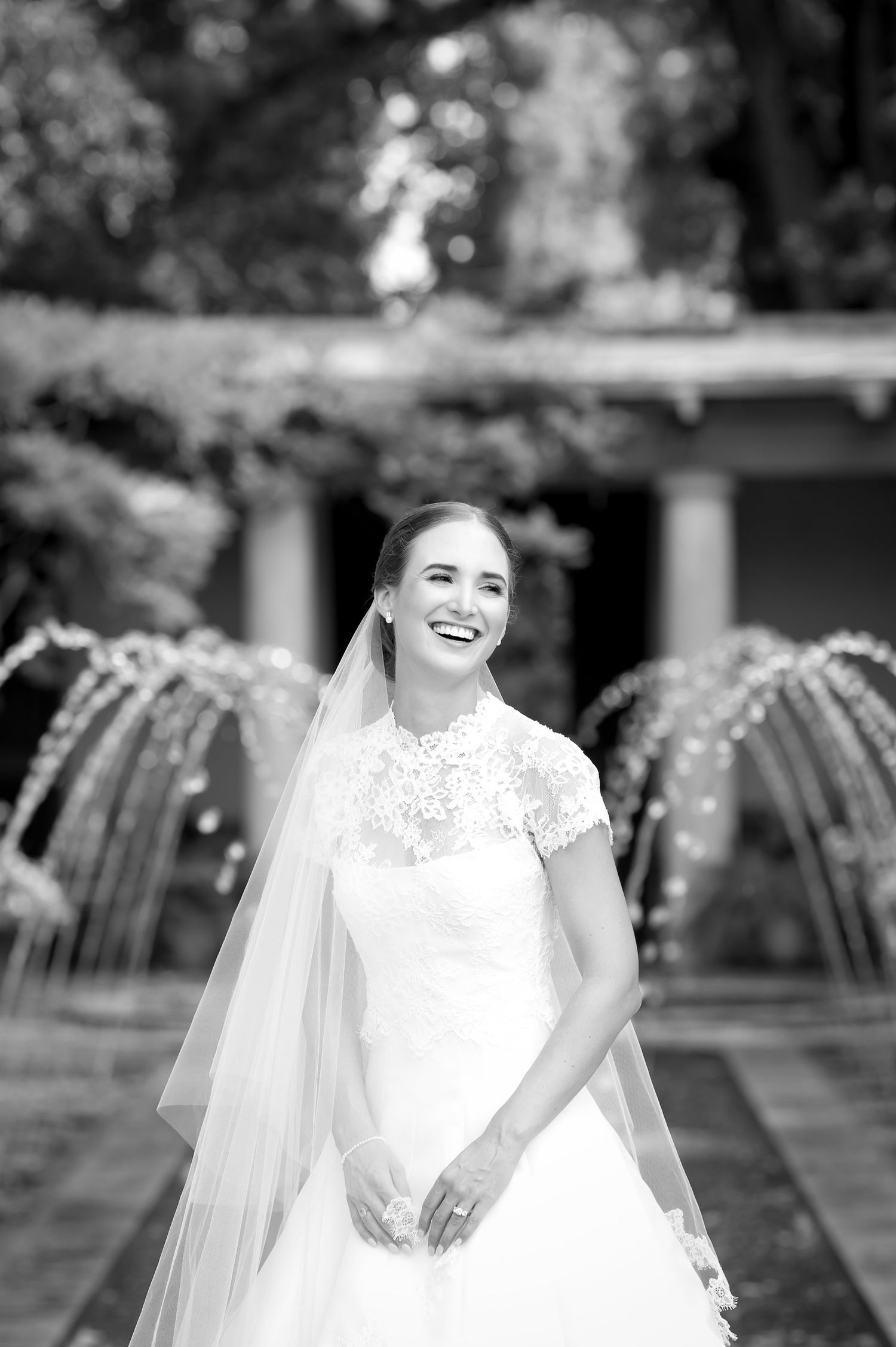 Black and white portraits capturing joyful moments in a wedding dress with delicate lace details.