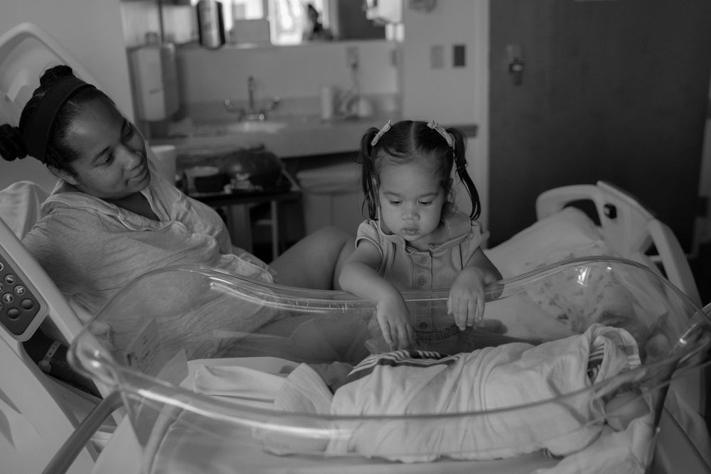 Black and white hospital scene showing medical equipment and monitoring devices.